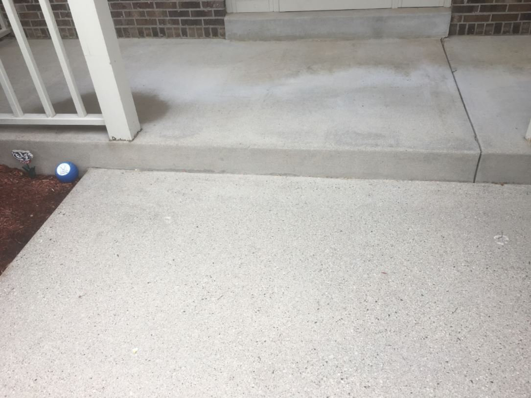 Before pressure washing of exterior concrete steps and porch by Blueline Cleaning Services.