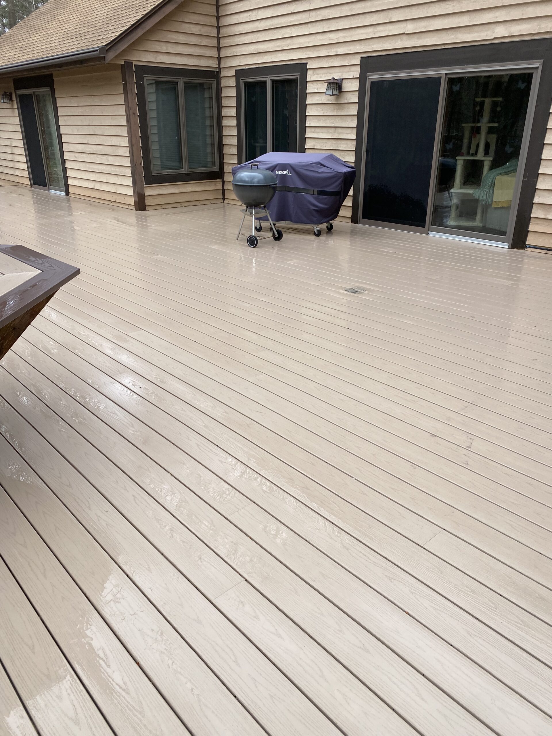 Before window cleaning project showcasing Blueline Cleaning Services work on a home deck.
